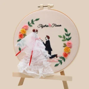 Handmade embroidery hoop art featuring a romantic wedding proposal scene, perfect for unique wedding gifts and personalized keepsakes.